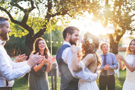 Bride and groom dancing at wedding reception outside